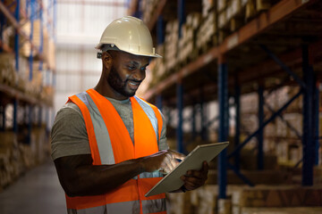 Warehouse worker using digital tablet to check stock in warehouse. 