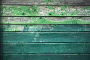 Old wooden grunge board painted in different shades of green color. Natural texture. Can be used like nature background