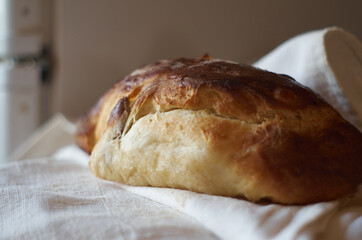 Homemade bread on a linen fabric close-up.  Sweet homemade bakery