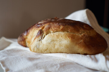 Homemade bread on a linen fabric close-up.  Sweet homemade bakery