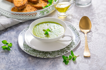 Homemade zucchini soup with tomato ciabatta bread and herbs