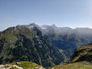 Naklejka premium hike on the mountain silbern in the canton of uri. away through the beautiful swiss mountains past flower meadows. 