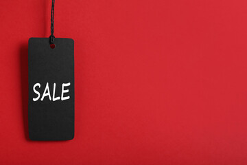 Sale tag on red background, space for text. Black Friday