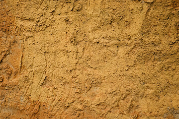 Ochre colored cement plaster wall texture