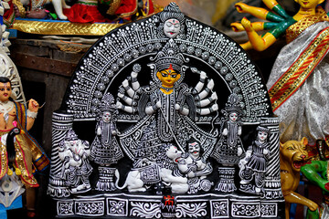 Clay idol of Goddess Devi Durga is in preparation for the upcoming Durga Puja festival at a pottery studio in Kolkata, West Bengal, India. - obrazy, fototapety, plakaty