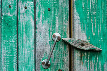 Green wooden antique door with latch. Old texture.