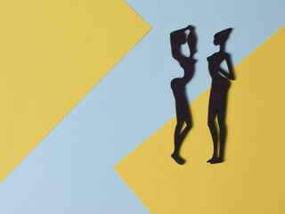 silhouettes of Egyptian women, self-made figures from wood on a background of pastel colors