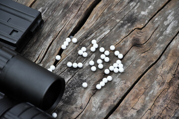 Airsoft or bbgun on black leather background. Selective and soft focus. concept for sport and...
