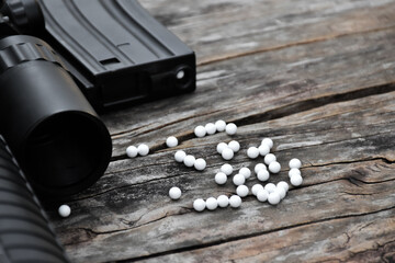 Airsoft or bbgun on black leather background. Selective and soft focus. concept for sport and...