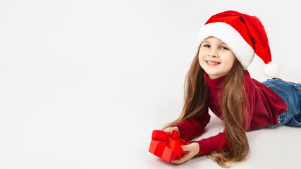 Christmas kid girl in Santa hat on white background. Copy space.