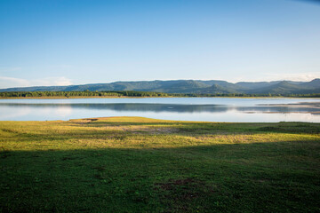 View of a reservoir with a mountain backdrop.