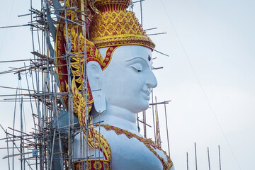 The Buddha image that is being built can be seen only on the upper part.