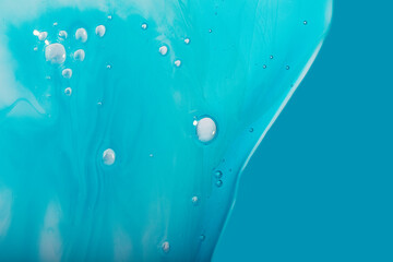 Blue liquid shampoo or cosmetics gel.Abstract cosmetic background.