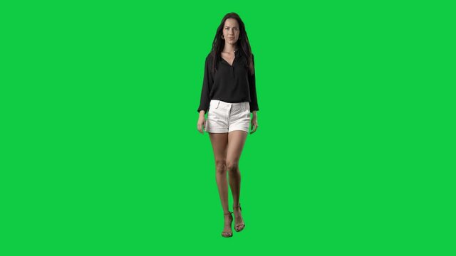Luxury well-dressed runway fashion model walking in slow motion. Full body on green screen chroma key background