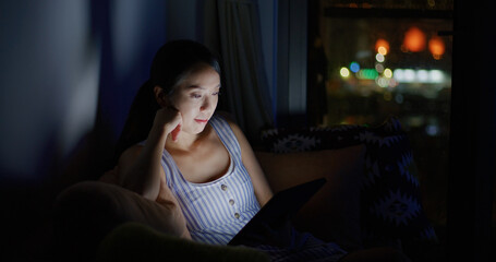 Woman work on tablet at home in the evening