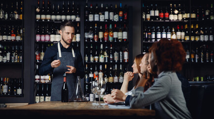 Master class for group of friends in restaurant, Sommelier talks about type of wine
