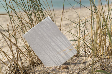White blank paper sheet card mockup with copy space on sea sand background. Summer stationery...