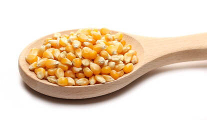 Popcorn kernels with wooden spoon isolated on white  