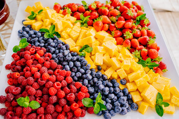 fruit assorted. raspberries, blueberries, pineapple and strawberries