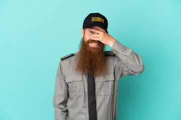 Redhead security man isolated on white background covering eyes by hands and smiling
