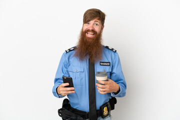 Redhead police man isolated on white background holding coffee to take away and a mobile