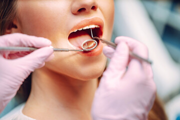 Overview of dental caries prevention. Dentist examining patient's teeth in modern clinic. Healthy...