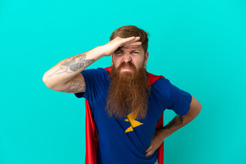 Redhead man in superhero costume and showing something © luismolinero