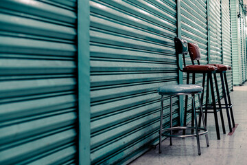 Closed curtains in a local market in downtown Mexico. Empty chairs.