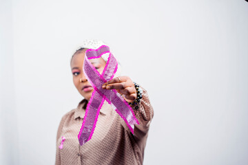 selective focus of african wowan, holding a ribbon covering portion of the face, close up image of...