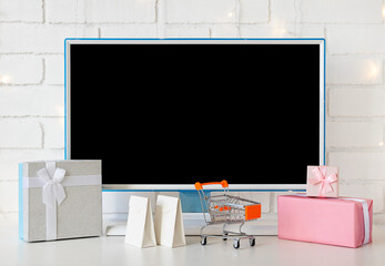 Online shopping concept. computer monitor and gifts and shopping for Christmas