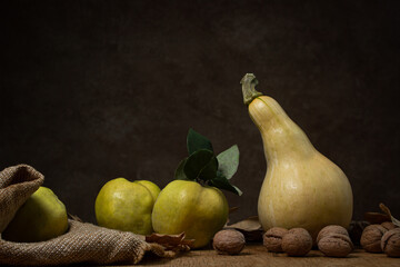 Autumn still life of vegetables and fruits on a brown background. Autumn harvest
