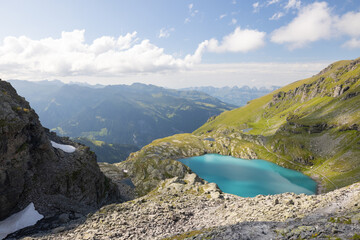 A wonderful view to the horizon at a beautiful sunset in the alps of Switzerland by an alpine lake called Schottensee. These colors by the sunset are just amazing. Epic clear blue water.