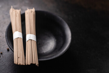 soba noodles buckwheat raw ready to cook meal snack on the table copy space food background 