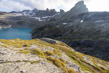 Wonderful scenery at an alpine lake called Wildsee in the canton of Saint Gallen. Epic sunset in the alps of Switzerland. Beautiful view with the tent in front and a perfect camping day.