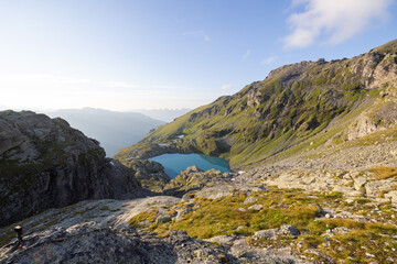 A wonderful view to the horizon at a beautiful sunset in the alps of Switzerland by an alpine lake called Schottensee. These colors by the sunset are just amazing. Epic clear blue water.