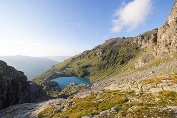 A wonderful view to the horizon at a beautiful sunset in the alps of Switzerland by an alpine lake called Schottensee. These colors by the sunset are just amazing. Epic clear blue water.