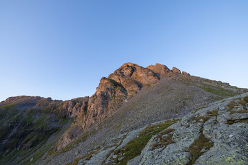 Wonderful scenery at an alpine lake called Wildsee in the canton of Saint Gallen. Epic sunset in the alps of Switzerland. Beautiful view with the tent in front and a perfect camping day.
