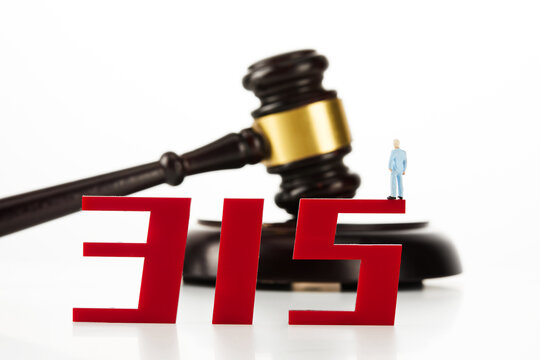 Red number 315 with a miniature figurine and judge hammer isolated on white background