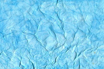 Winter background. Watercolor of a delicate blue color with a textured background. Crumpled paper.