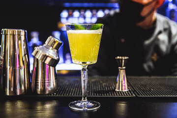 Yellow cocktail on the bar.