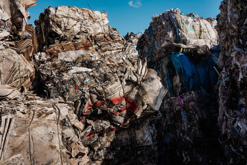Photo of a large amount of waste paper, carton, car and plastic