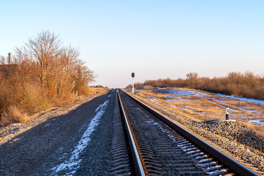 Semaphore: green light is on. Rails railroad at sunset. Semaphore green light. Rails railroad at sunset. Topic: railroad