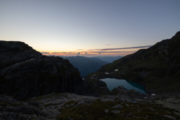 Wonderful view over a beautiful alpine lake in Switzerland called Schottensee. Epic sunrise over a perfect blue lake.