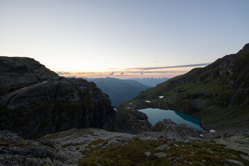 Wonderful view over a beautiful alpine lake in Switzerland called Schottensee. Epic sunrise over a perfect blue lake.