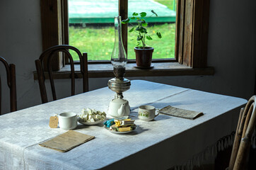 kerosene lamp and tea cups in a village house