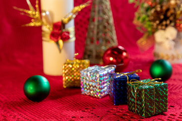 Christmas arrangement with gift packages, balls and ornaments and blurred background. Selective focus