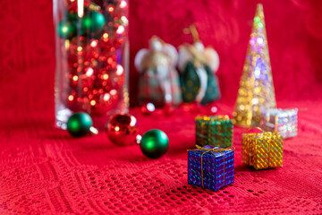 Christmas arrangement with gift packages, balls and ornaments and blurred background. Selective focus