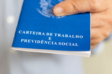 man with Brazilian work card. concept of employment and salary increase. Translation: Work and...
