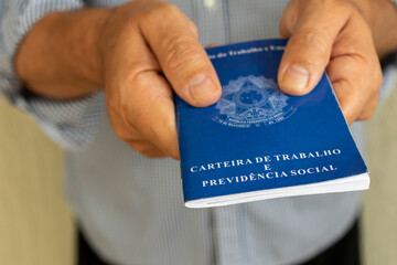 man with Brazilian work card. concept of employment and salary increase. Translation: Work and Social Security Card, in Portuguese