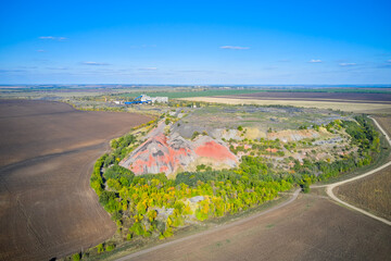 Aerial view of the landfill and the surrounding agricultural landscape. Shooting from a drone.